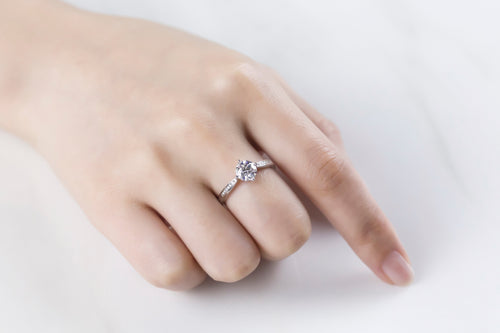 Glinting Solitaire Round Moissanite with Side Studded Shank Engagement Ring in Sterling Silver